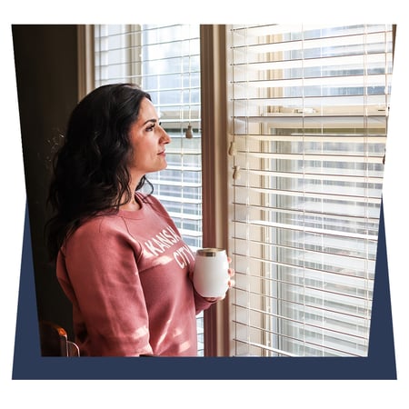 Lady with a coffe infront of window