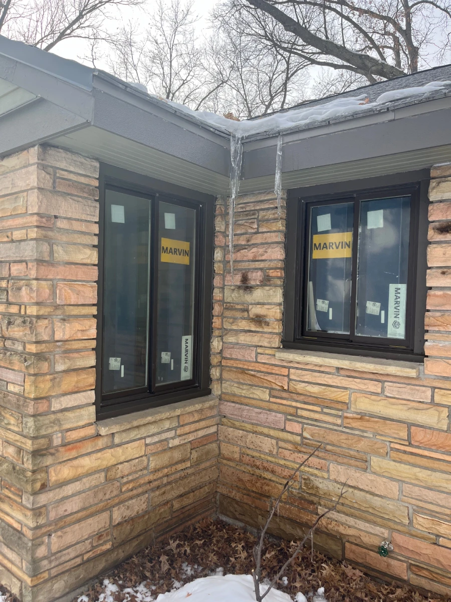 Snow-covered home with replaced windows