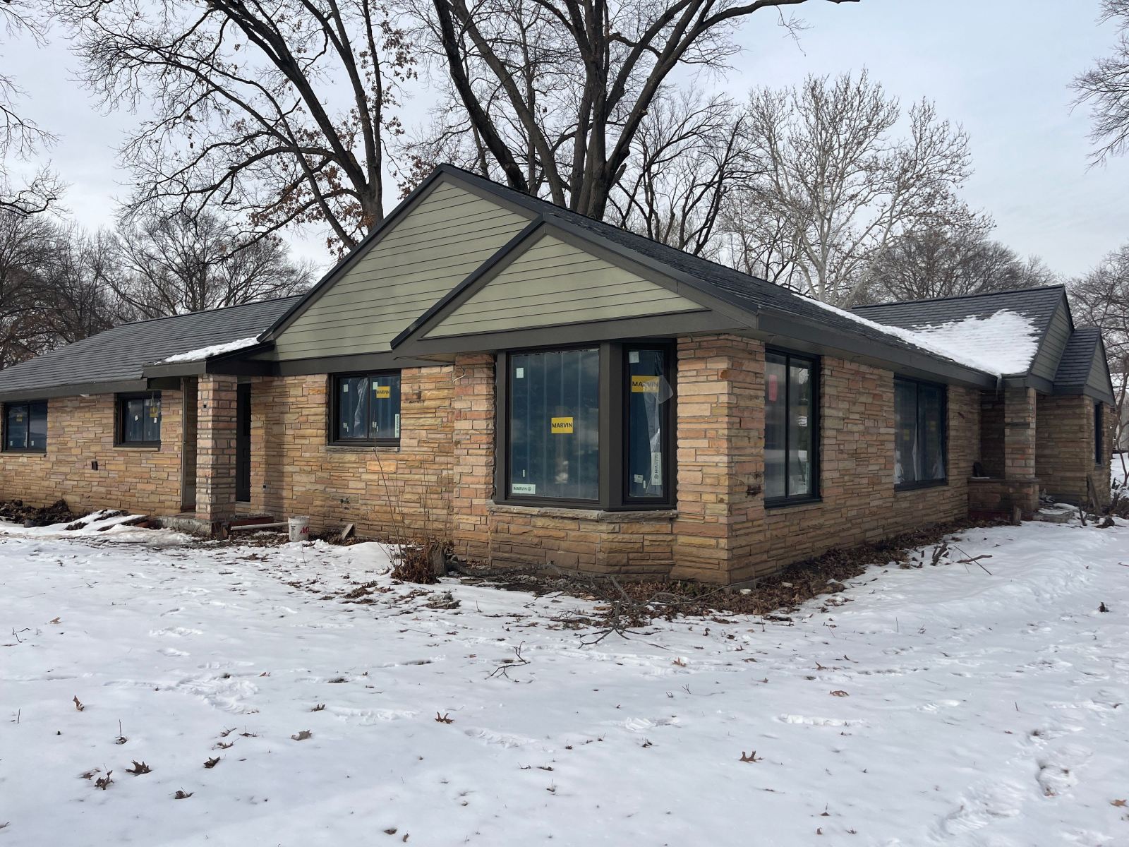 Snow-covered home with replaced windows