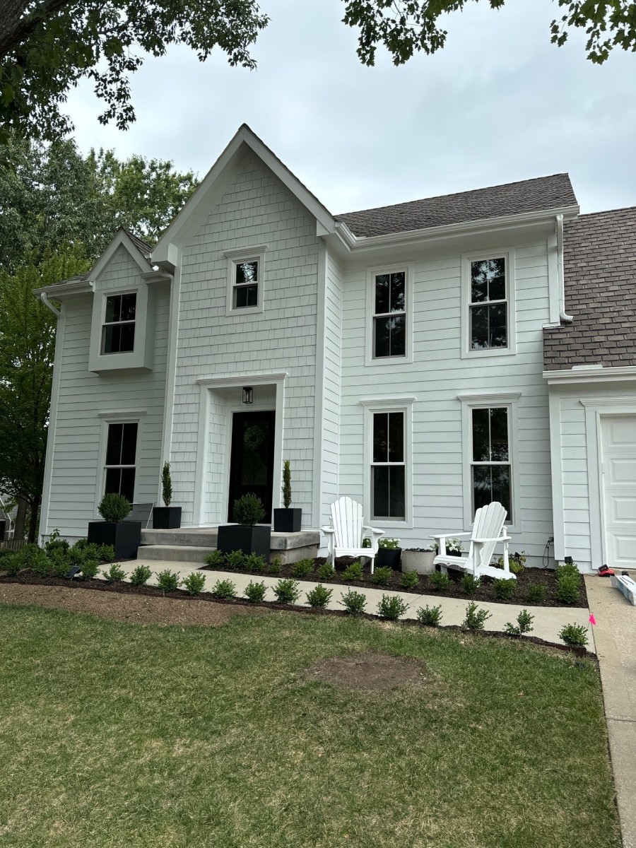 White two-story estate home in Loch Lloyd, MO with black-trimmed replacement windows